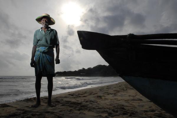 Laya Project man standing next to boat